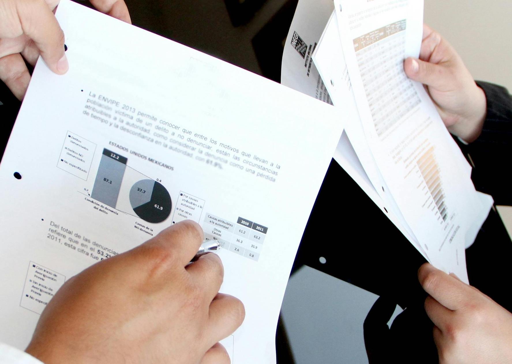  two employees review and reconcile data manually